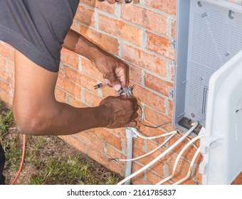 Cable Repair Man Servicing A Coaxial Internet And Video Cable Junction On A Residential Home Façade.