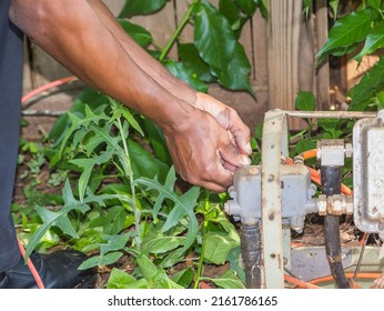 Cable Repair Man Servicing A Coaxial Internet And Video Cable Junction On A Residential Home Façade.