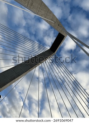 Cable Stayed Bridge Cables Framed with Blue Sky and Clouds Obtuse and Bold Masculine Lines