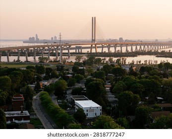 Cable stayed bridge over St Lawrence River at golden sunrise near Montreal and Brossard, Canada. g.