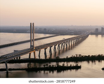 Cable stayed bridge over St Lawrence River at golden sunrise near Montreal and Brossard, Canada. g.