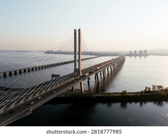 Cable stayed bridge over St Lawrence River at golden sunrise near Montreal and Brossard, Canada. g.