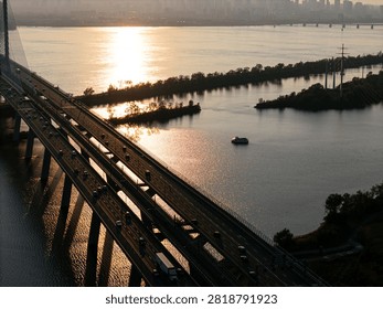 Cable stayed bridge over St Lawrence River at golden sunrise near Montreal and Brossard, Canada. g.