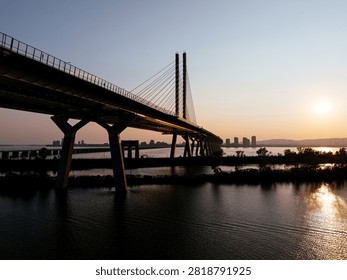 Cable stayed bridge over St Lawrence River at golden sunrise near Montreal and Brossard, Canada. g.