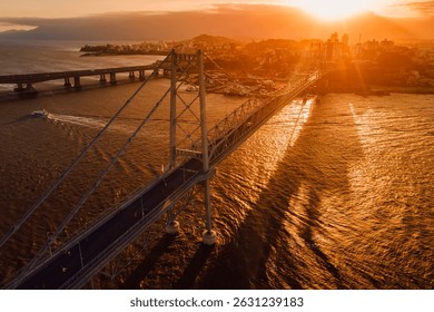 Cable stayed old bridge with sunset sky in Florianopolis, Brazil. Aerial view