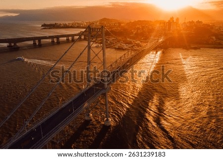 Cable stayed old bridge with sunset sky in Florianopolis, Brazil. Aerial view