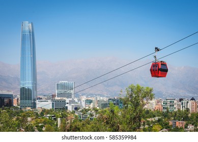 The cable way with different colored cabins on the background of Santiago, Chile.