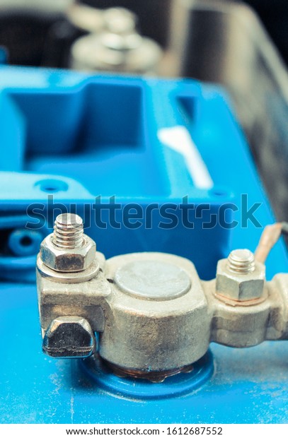 Cables connected to car battery under hood\
of car. Technology in\
transportation