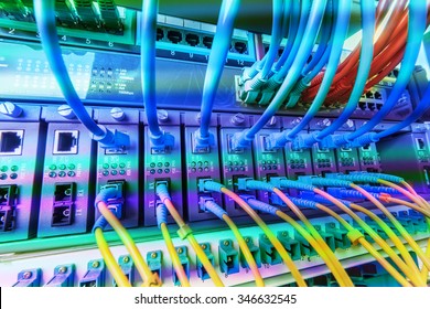 cables connected to an optic ports and UTP Network cables connected to ethernet ports.