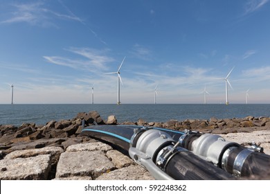 Cables in front of a group of windmills for renewable electric energy production, Westermeerwind, Noordoostpolder, Flevoland, Urk, The Netherlands
