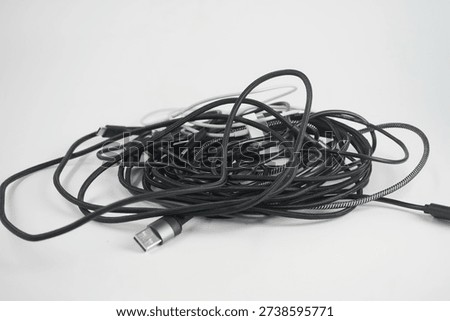 Cables are tangled on a plain background