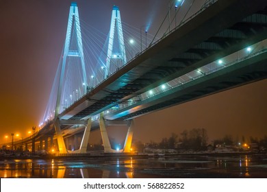 Cable-stayed bridge across the river. The bridge with night lighting.