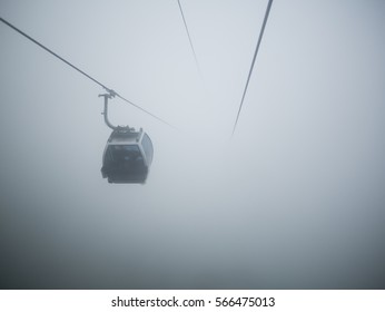 Cableway into thick fog. Cabin into air - Powered by Shutterstock
