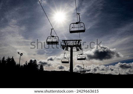 Cableway silhouette with sun and clouds on sky, Lipno nad Vltavou, Czech Republic, Europe