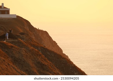 Cabo da Roca, sunset, Atlantic Ocean, lighthouse, coastal, Portugal, cliffs, ocean view, dramatic sky, seascape, golden hour, nature, picturesque, horizon, waves, rugged coastline, dusk, landmark, tra - Powered by Shutterstock