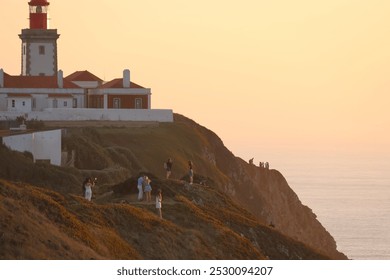 Cabo da Roca, sunset, Atlantic Ocean, lighthouse, coastal, Portugal, cliffs, ocean view, dramatic sky, seascape, golden hour, nature, picturesque, horizon, waves, rugged coastline, dusk, landmark, tra - Powered by Shutterstock