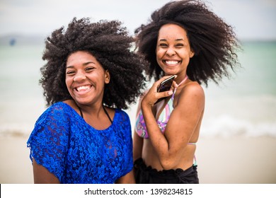 Cabo Frio Brazil - 24.11.2018. Brazilian Girlfriends With Curly Hair Genuinely Laugh On The Beach