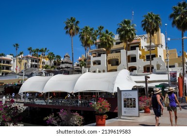 Cabo San Lucas, Mexico - February 27, 2022: Tourists Walk Near Oyster Bar In The Marina Of Los Cabos.