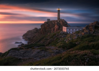 Cabo Vilan lighthouse during a colorful sunset on the coast of Galicia. Camariñas, Spain - Powered by Shutterstock