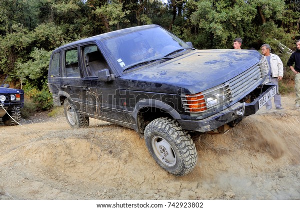 CABRIERES,\
FRANCE - OCTOBER 14: Range Rover in bad shape ready to tip in a\
hole of a trial circuit, october 14,\
2017.