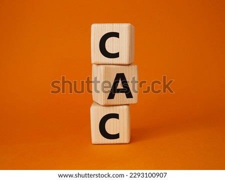 CAC - Customer Acquisition Cost symbol. Wooden cubes with word CAC. Beautiful orange background. Business and Customer Acquisition Cost concept. Copy space.