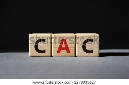 CAC - Customer Acquisition Cost symbol. Wooden cubes with word CAC. Beautiful grey background. Business and Customer Acquisition Cost concept. Copy space.