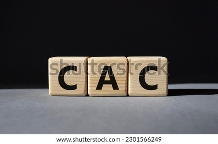 CAC - Customer Acquisition Cost symbol. Wooden cubes with word CAC. Beautiful grey background. Business and Customer Acquisition Cost concept. Copy space.