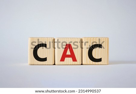 CAC - Customer Acquisition Cost symbol. Wooden cubes with word CAC. Beautiful white background. Business and Customer Acquisition Cost concept. Copy space.