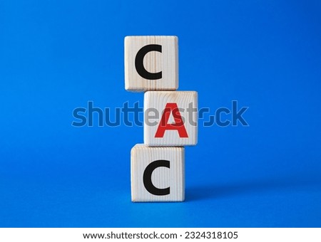 CAC - Customer Acquisition Cost symbol. Wooden cubes with word CAC. Beautiful blue background. Business and Customer Acquisition Cost concept. Copy space.