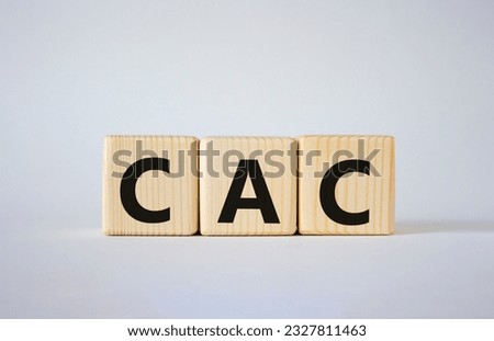 CAC - Customer Acquisition Cost symbol. Wooden cubes with word CAC. Beautiful white background. Business and Customer Acquisition Cost concept. Copy space.