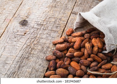 Cacao Beans On Wooden Bacground