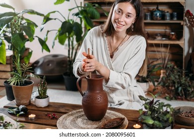 Cacao Ceremony In Atmospheric Space With Green Plants And Candles. Woman Making Ritual Healthy Drink From Cocoa Beans Person Whipping Hot Fresh Chocolate Drink