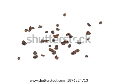 Cacao nibs, a pieces of broken cocoa beans isolated, top view