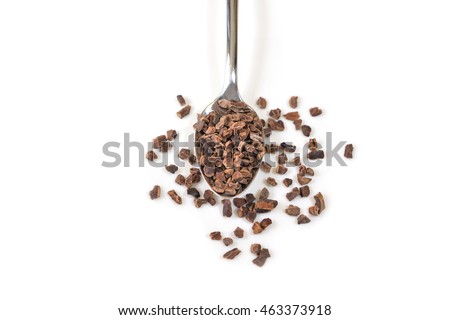 Cacao nibs in a spoon on white background - isolated