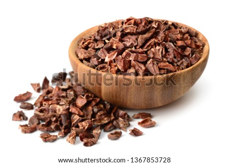 cacao nibs in the wooden bowl, isolated on white background
