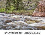 Cache la Poudre River west of  Fort Collins in northern Colorado - springtime scenery with a snow melt run off