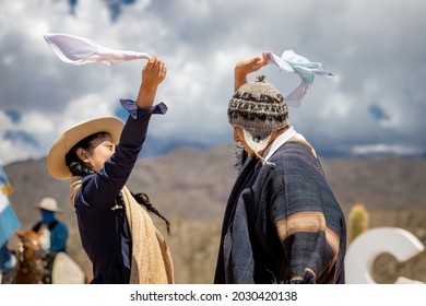 Cachi, Argentina - January 8, 2021: Young couple in traditional costumes dance at the welcoming festival for new tourists