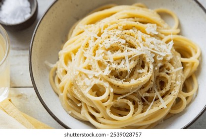 Cacio e Pepe: A simple yet flavorful pasta dish with Pecorino Romano cheese and black pepper, creating a creamy, peppery sauce. - Powered by Shutterstock