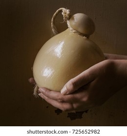 Caciocavalio cheese over rustic background. Square image