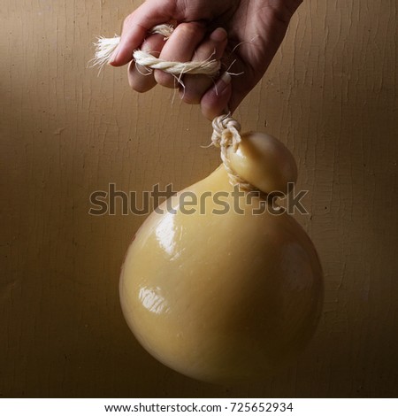 Caciocavalio cheese over rustic background. Square image