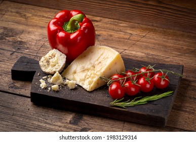 Caciotta and belper knole, with cherry tomatoes and sweet pepper. On wood background - Powered by Shutterstock