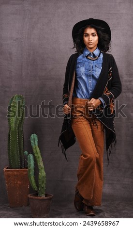 Cactus, fashion or woman in cowgirl, portrait, wild west culture and cool clothes in studio on grey background. Native American person, western lady and stylish model with pride, boho style or plants
