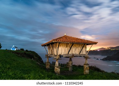 CADAVEDO, ASTURIAS, SPAIN, September 30, 2017. Hórreo And Hermitage Santa María De Riégala (La Regalina)located In The Background On The Asturian Coast In Northern Spain.