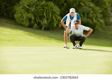 Caddy and golfer preparing to putt