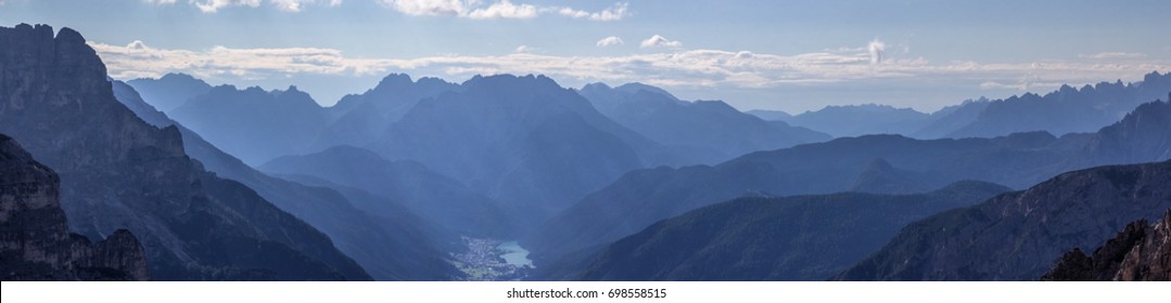 Cadini Valley with the city of Auronzo in the Dolomite Mountains, with blue haze