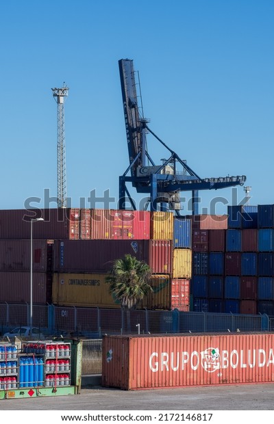 Cadiz,\
Spain. June,22nd,2022. Shipping containers. Port, freight, cargo,\
docks. Stacks of colourful metal crates waiting for transportation.\
With vehicles and cranes. A busy working\
port.