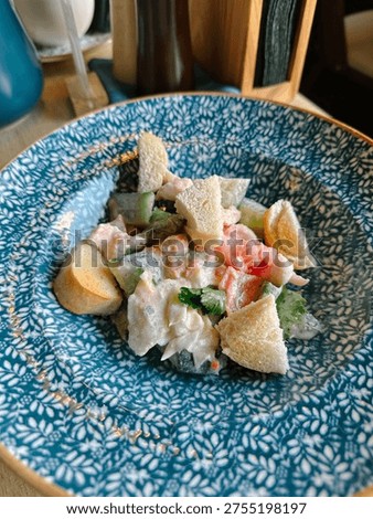 Caesar salad in a beautiful patterned plate. Vertical
