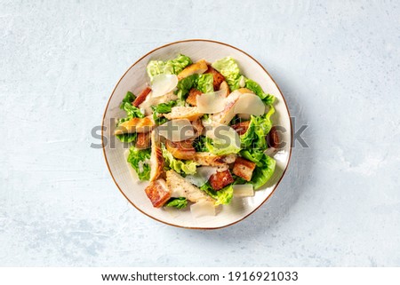Caesar salad with chicken, romaine and Parmesan, shot from the top