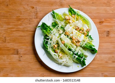 Caesar Salad. Classic American Salad With Romaine, Caesar Dressing, Red Onions, Bacon Lardons, Parmesan Cheese, Olive Oil, Lemon Juice, Salt And Pepper. A Fine Dining Restaurant Classic.