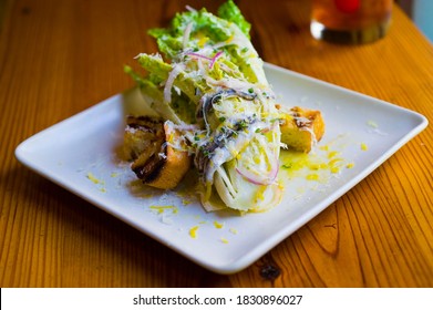 Caesar Salad. Classic American Salad With Romaine, Caesar Dressing, Red Onions, Bacon Lardons, Parmesan Cheese, Olive Oil, Lemon Juice, Salt And Pepper. A Fine Dining Restaurant Classic.